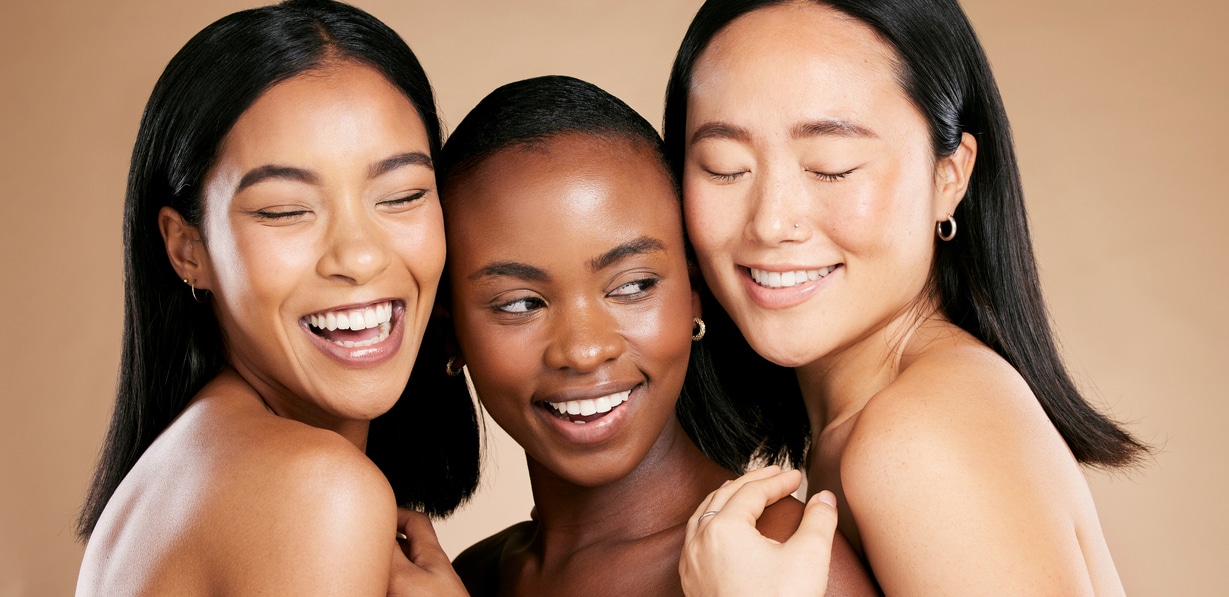 Skincare, beauty and diversity, happy women with smile and eyes closed on studio background. Health, wellness and luxury cosmetics, healthy skin care and beautiful, friendly people in natural makeup