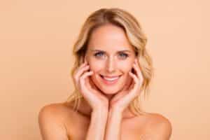 Woman with beautiful glowing skin after trying fractional laser treatment.