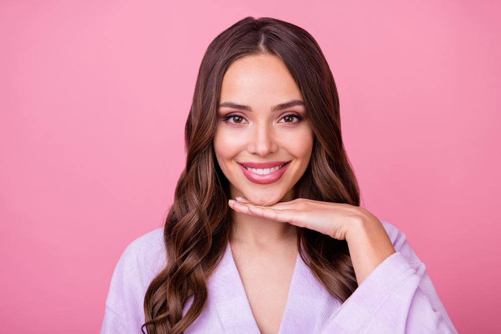 Woman with smooth, glowing skin smiling after comparing Clear + Brilliant and chemical peel options. Woman with smooth, glowing skin smiling after comparing Clear + Brilliant and chemical peel options.
